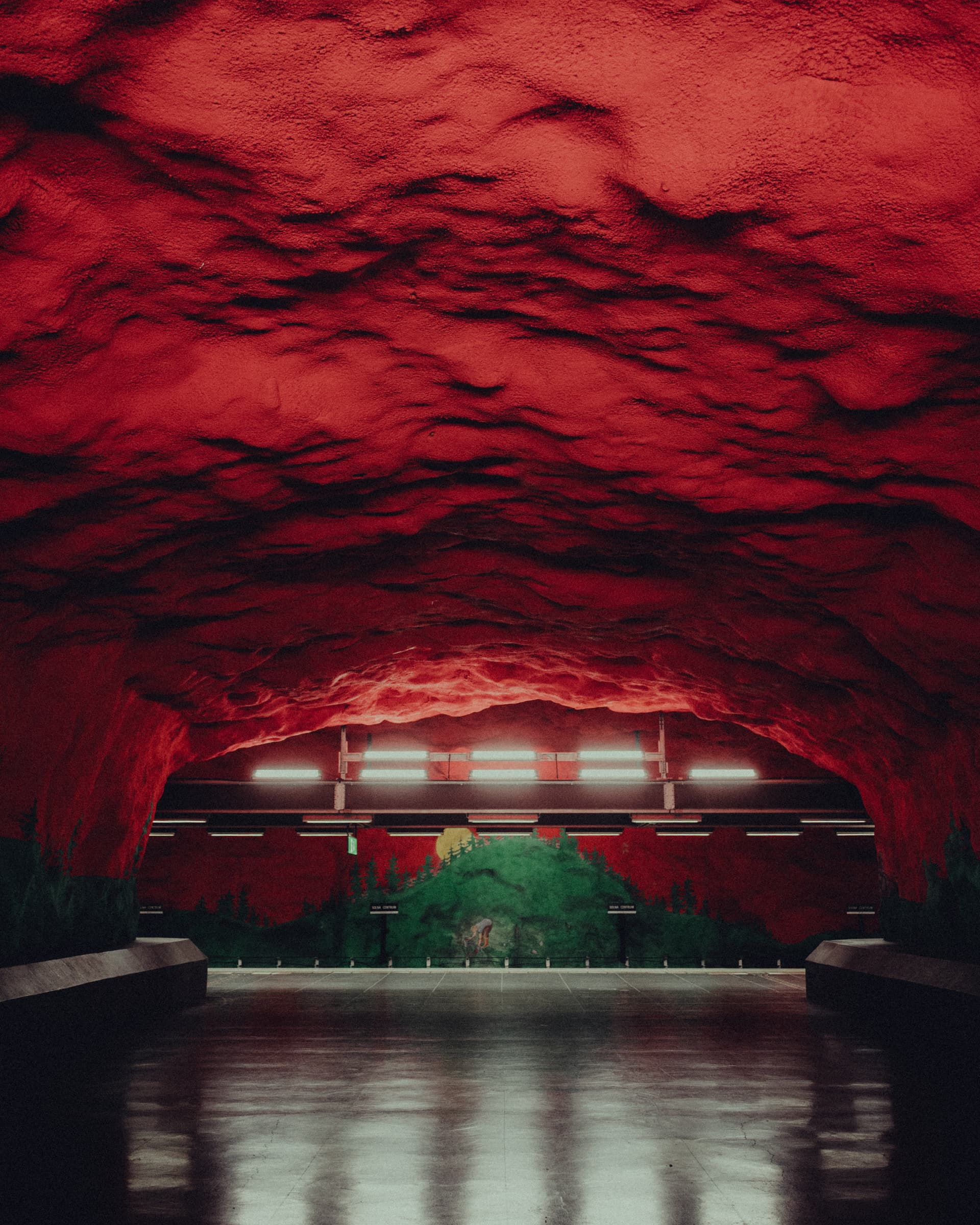 Red-painted rock ceiling above the platform at Solna centrum metro station, Stockholm