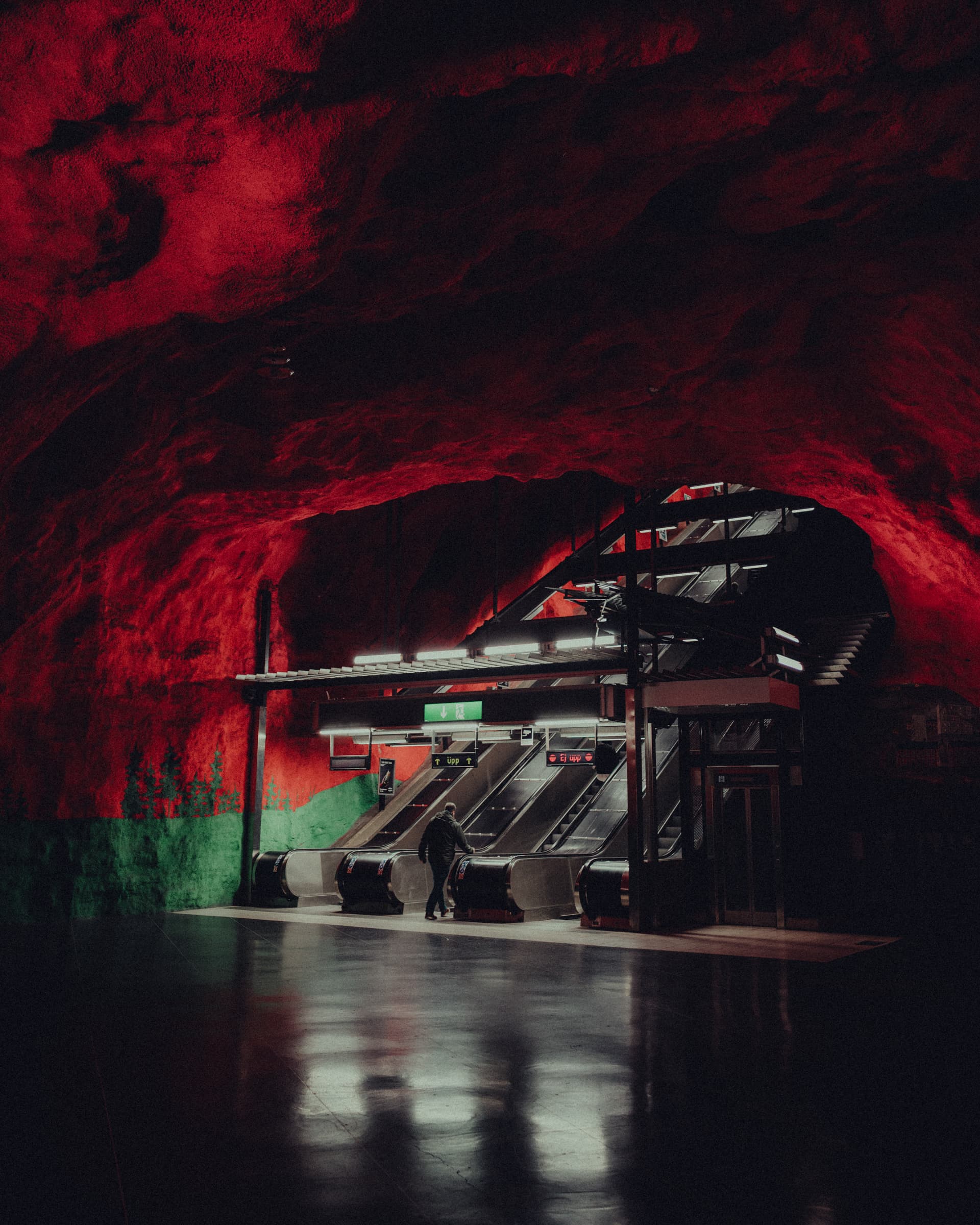 Escalators rising through the red cave of Solna centrum metro station, Stockholm